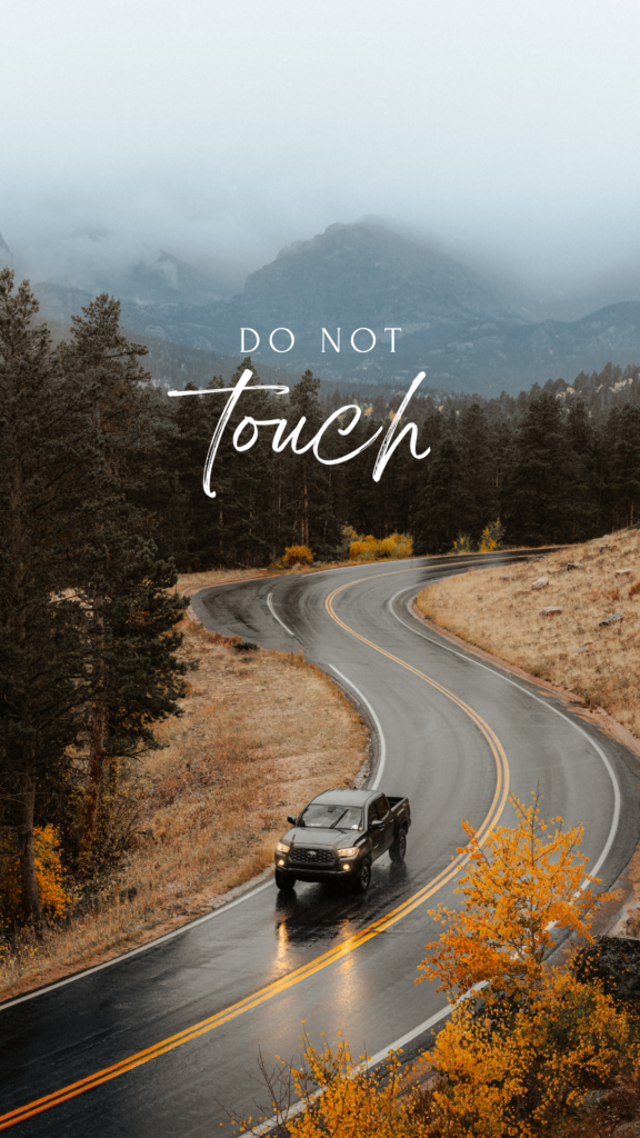 a car is moving on a road in the middle of the mountains covered with fog