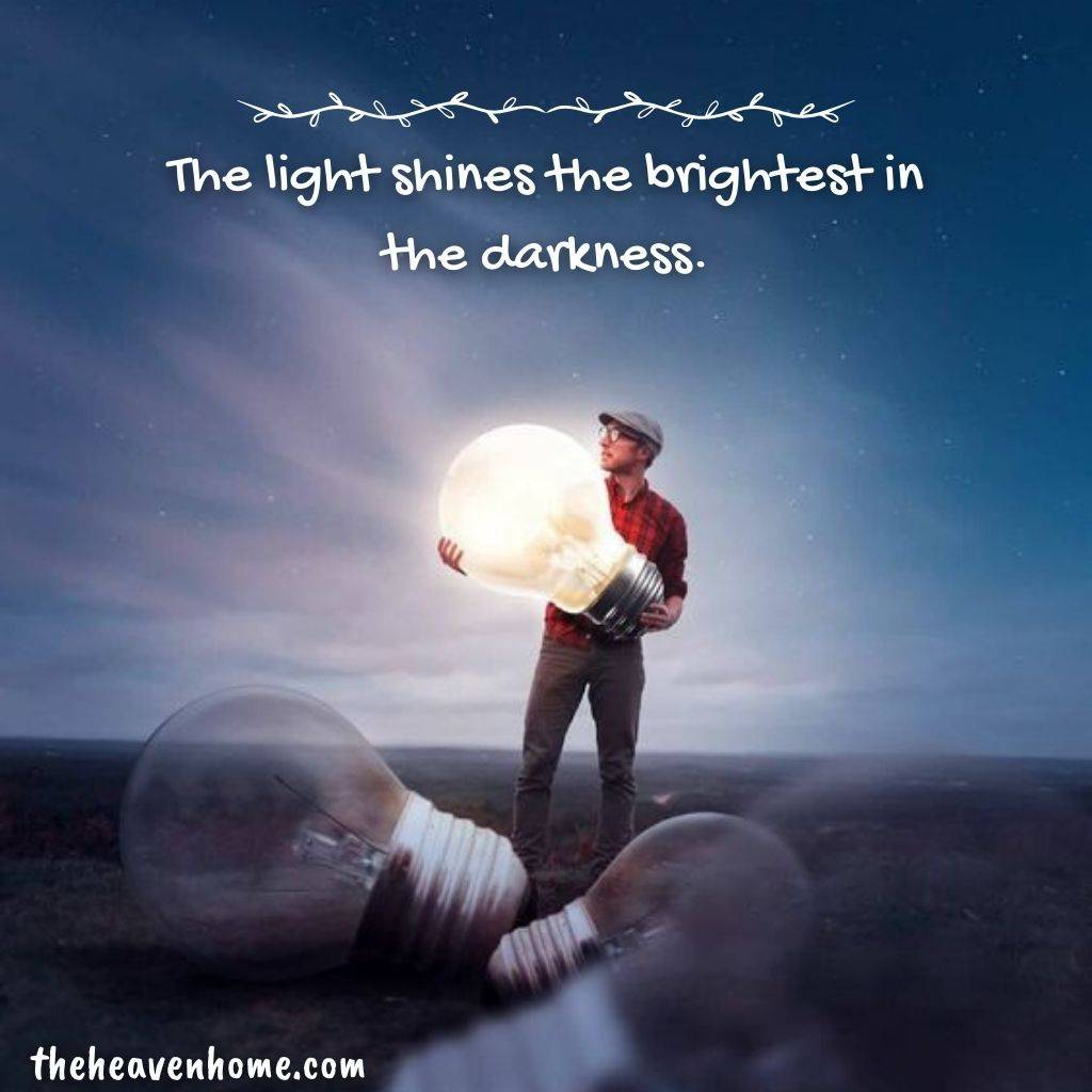 a men holding a big bulb in the dark image with a motivational quote