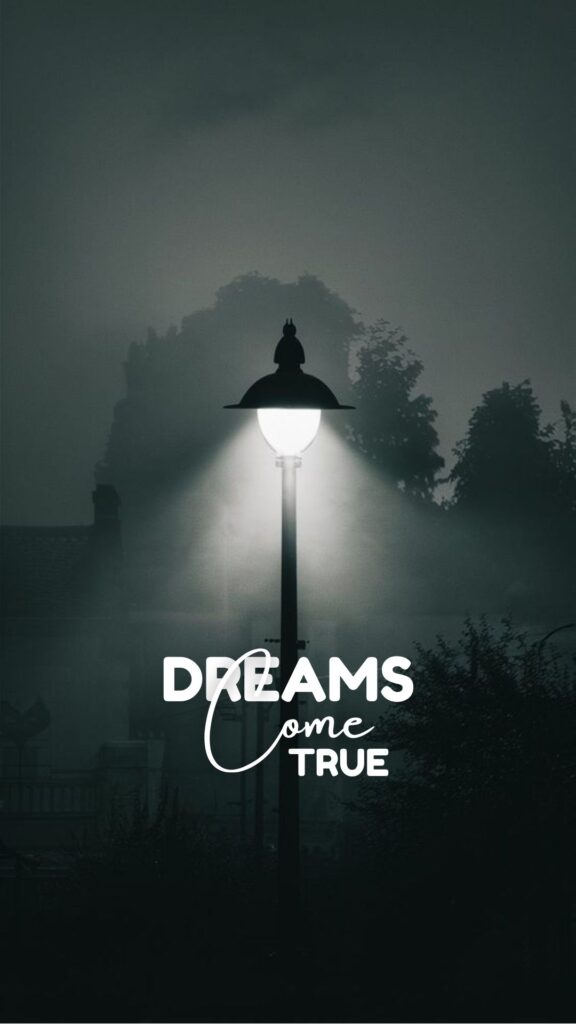 "Misty streetlight with 'Dreams Come True' text, inspirational wallpaper with dark, moody background"